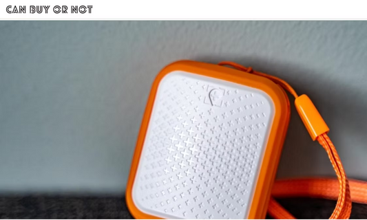 Tack GPS Location Tracker held in a hand next to a phone showing the tracking app, from a 2021 product review