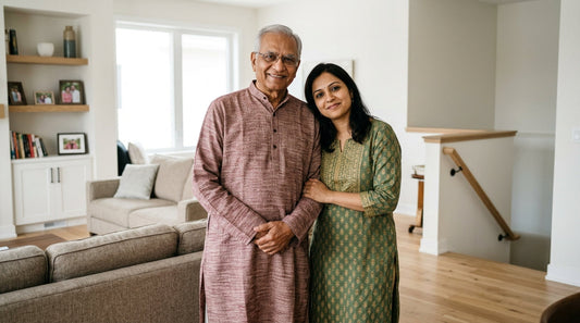 An older adult supported by a family member at home, illustrating fall prevention and senior safety